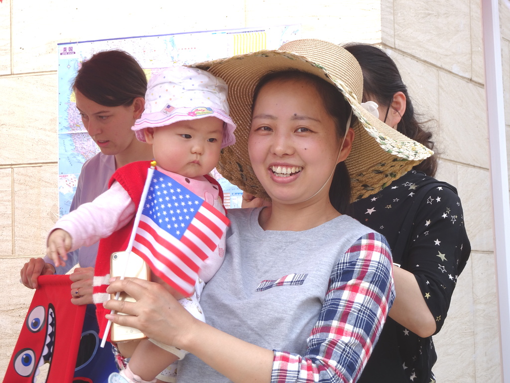 visitor on campus holding her baby