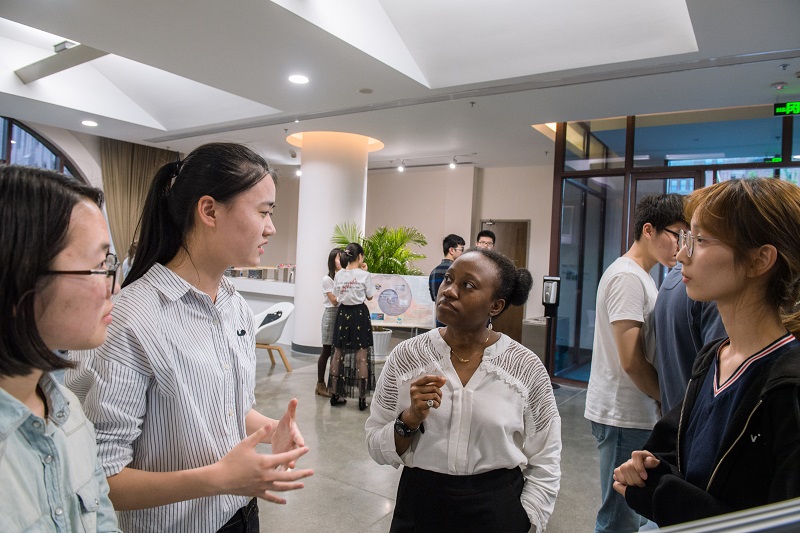 students discussing poster with a Postdoctoral staff member