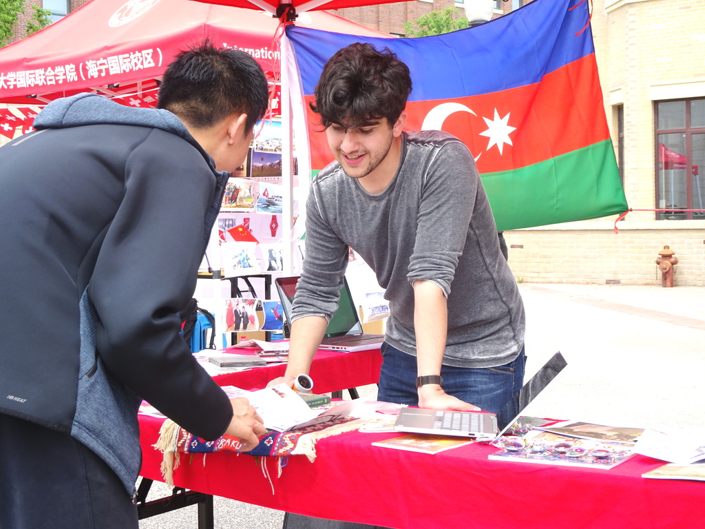 Student on campus hosting a stall with a customer