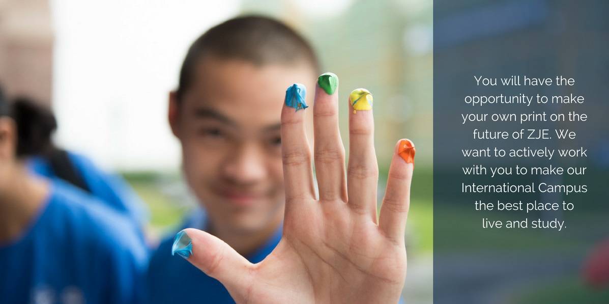 A student holding up his hand with painted fingetips